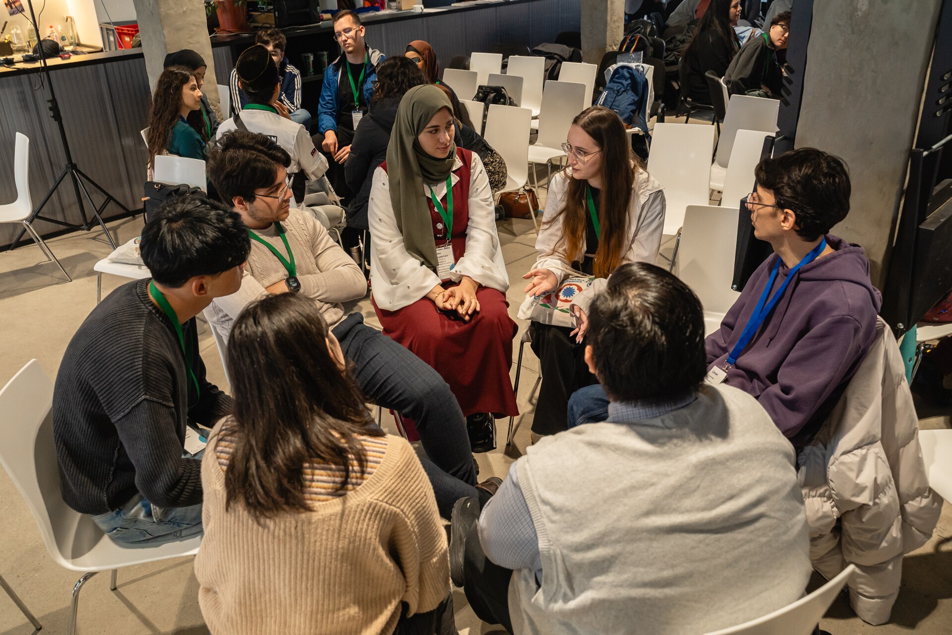 A group of young people talking in a discussion circle